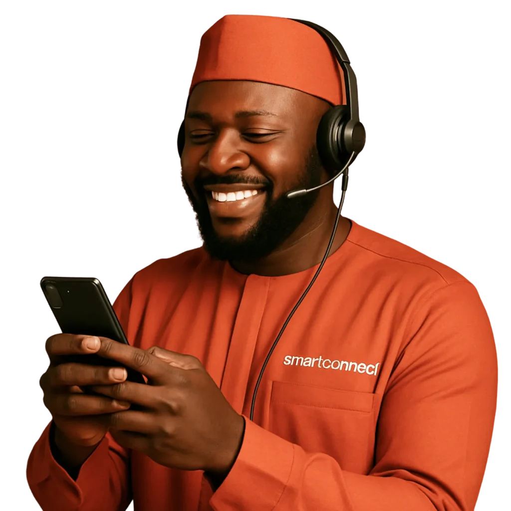 An Image of a Nigerian man with orange colored native attire happily operating his smartphone