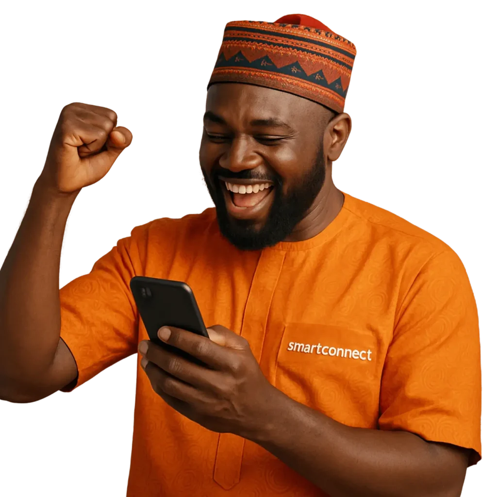 An Image of a Nigerian man with orange colored native attire happily operating his smartphone